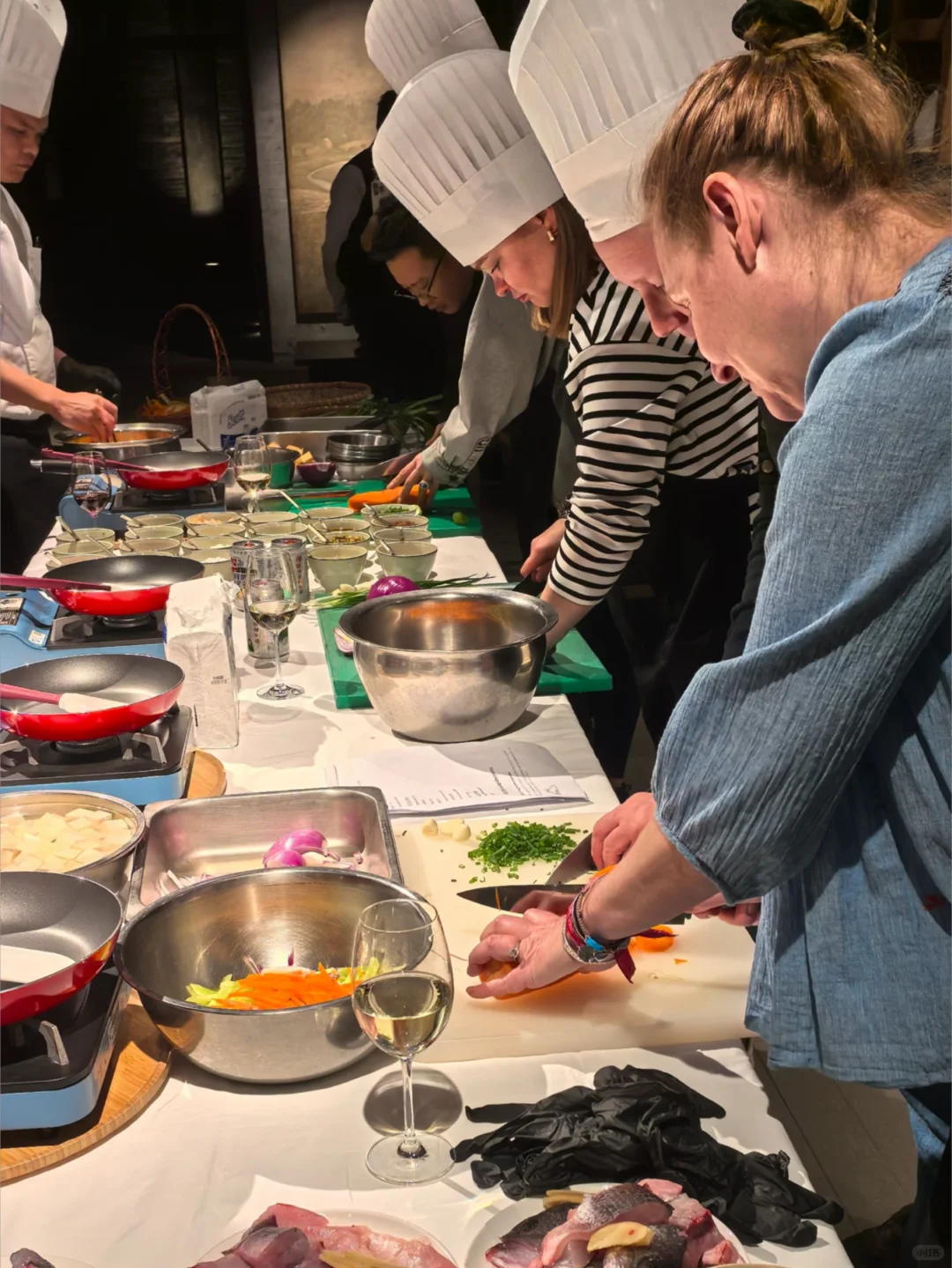 Travelers learning to prepare Chinese food in a cooking workshop